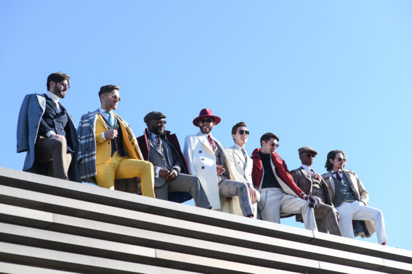 The influencers of Pitti are posing on top of the exhibition spaces looking over the crowd and photographs
